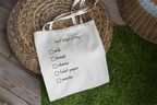 White tote bag with 'Don't forget to buy' checklist boxes for milk, bread, cheese, toilet paper, snacks.
