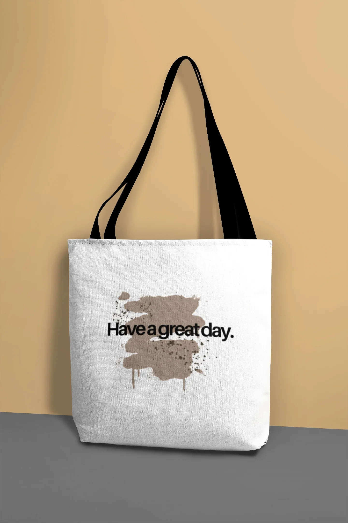 White canvas tote bag with black handles, “Have a great day.” splash graphic