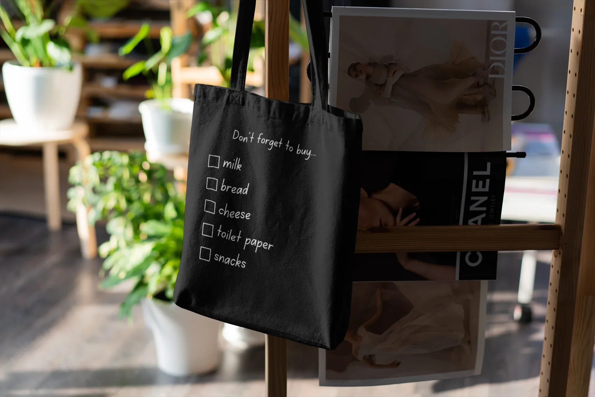 Black grocery tote bag with 'Don't forget to buy' checklist boxes for milk, bread, cheese, snacks.