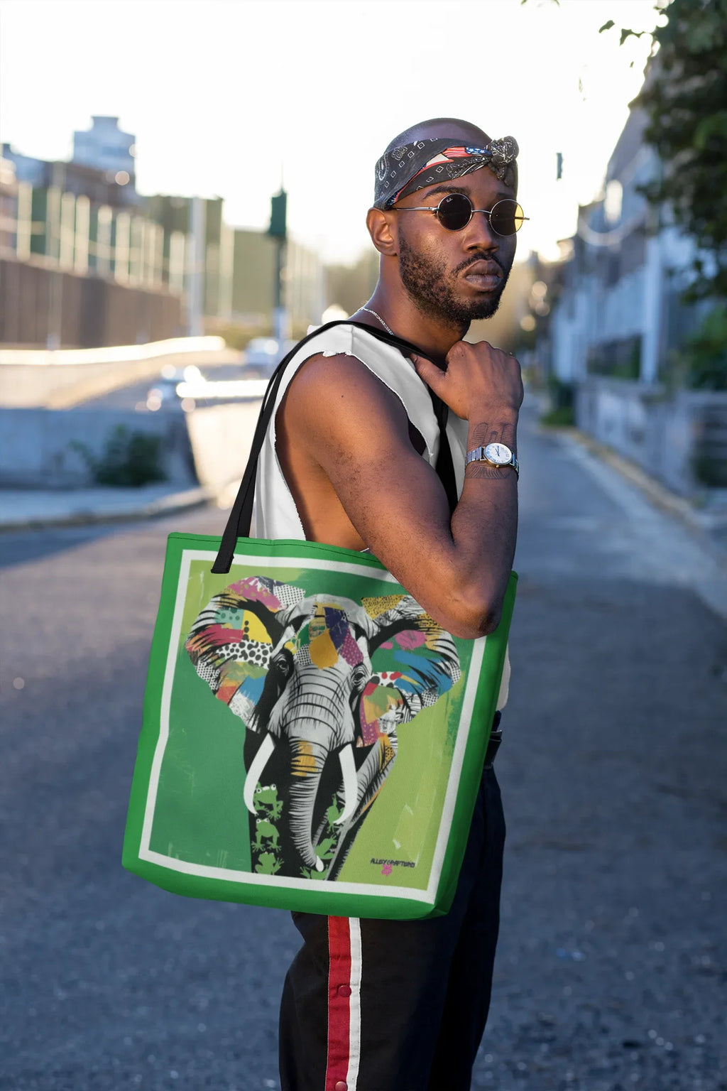 Green tote bag with colorful pop art elephant print and black handles