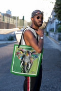 Green tote bag with colorful pop art elephant print and black handles