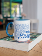 Navy accent coffee mug with blue floral line art and 'Be Kind to yourself!' text