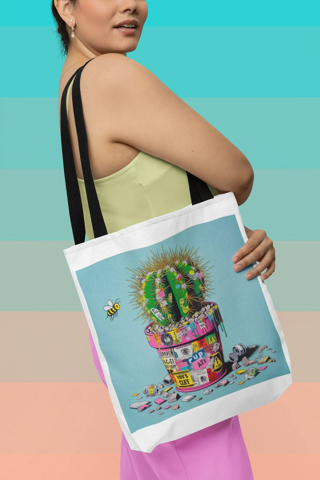 Tote bag with cactus artwork, light blue panel, black shoulder straps