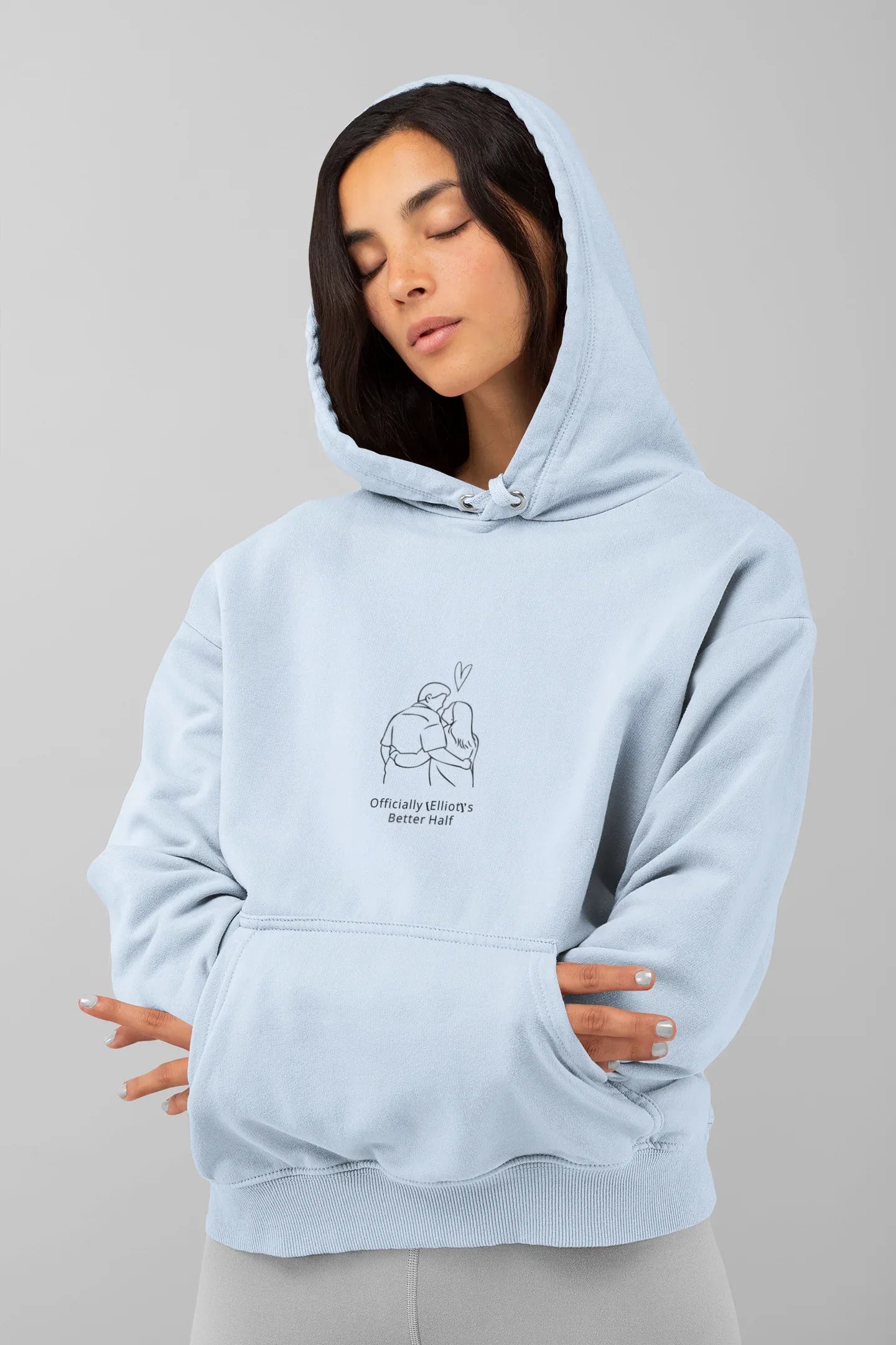 Light blue hooded sweatshirt with front couple graphic and kangaroo pocket
