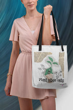 White tote bag with green plant graphic and 'Plant vibes only' text, carried on shoulder