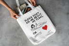 White canvas tote bag with black straps and quote print: “Please don’t ask me about my plans”