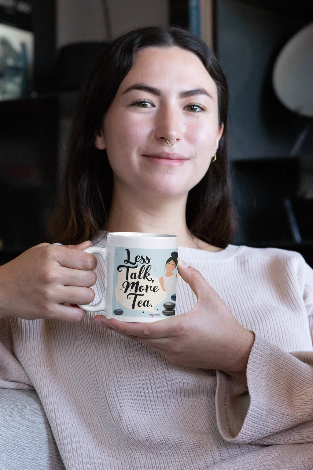 Tea mug held by person in a light sweater, featuring 'Less Talk, More Tea'