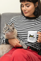 White mug held with black cat and yellow eyes, 'Be careful, hot tea!' design