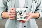 White ceramic tea mug with 'Less Talk, More Tea' quote and woman illustration