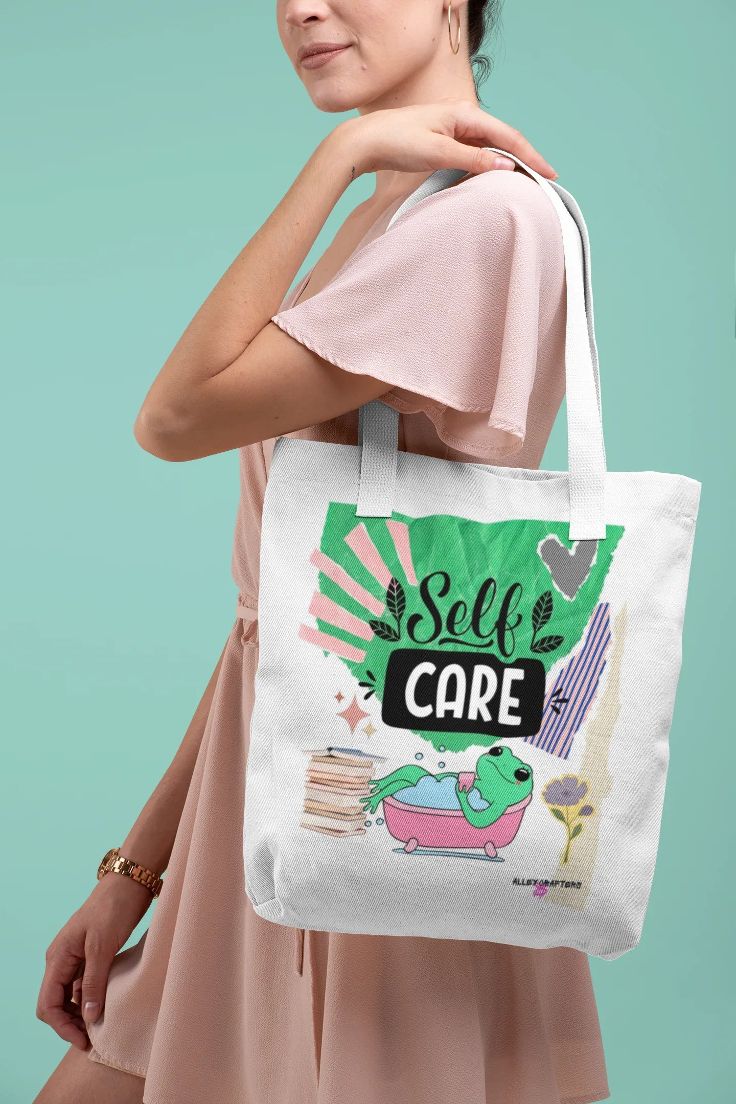 White tote bag with “Self Care” lettering and green frog artwork