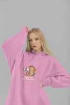 Pink hooded sweatshirt worn with hood up, featuring a woman megaphone graphic