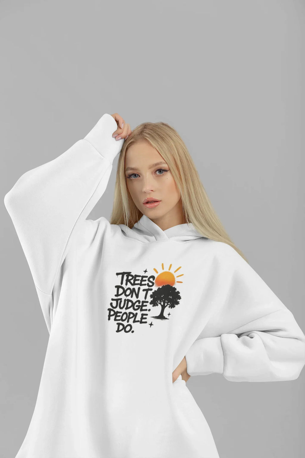 White hoodie worn by a model, featuring a chest graphic with tree and sun