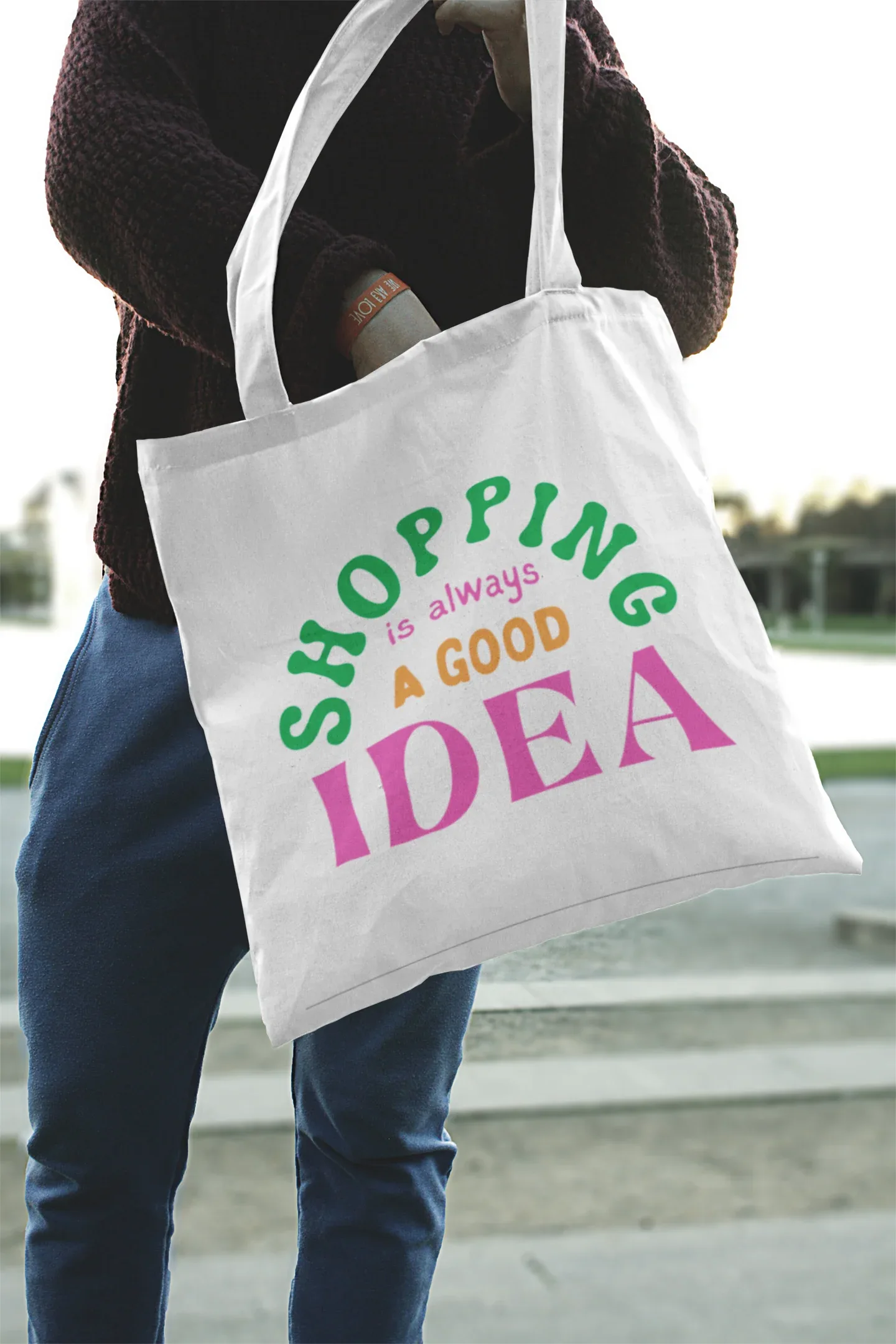 White tote bag with green "SHOPPING" and pink "IDEA" lettering