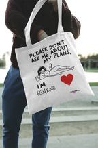 White canvas tote bag being carried, “Please don’t ask me about my plans” print and red heart