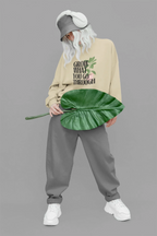 Beige sweatshirt with “Grow What You Go Through” text and leaf graphic