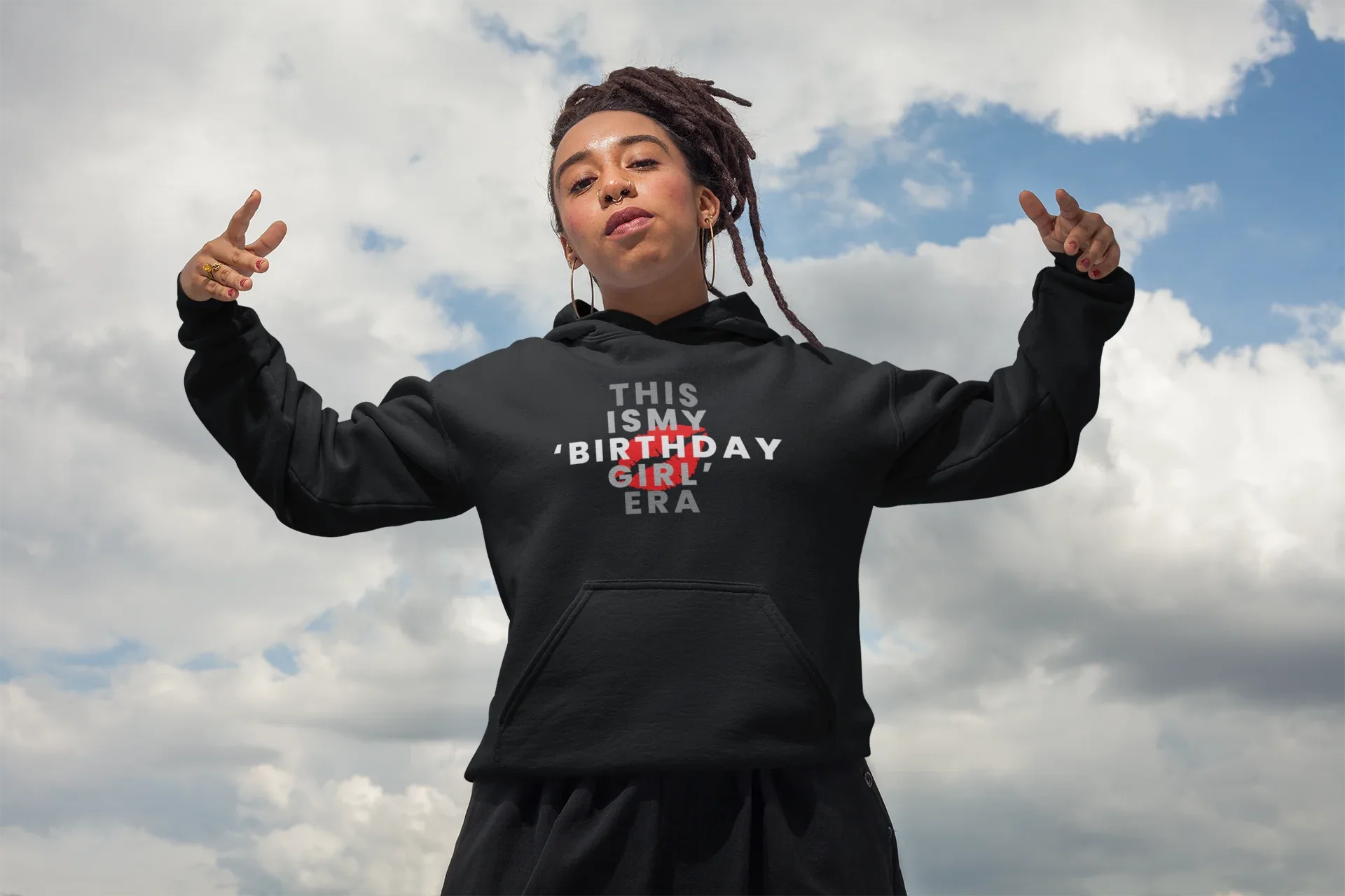 Black pullover hoodie on model with hood, wearing "THIS IS MY BIRTHDAY GIRL ERA" front print
