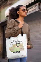 White tote bag on model, with “who loves MATCHA” print and small heart icons.