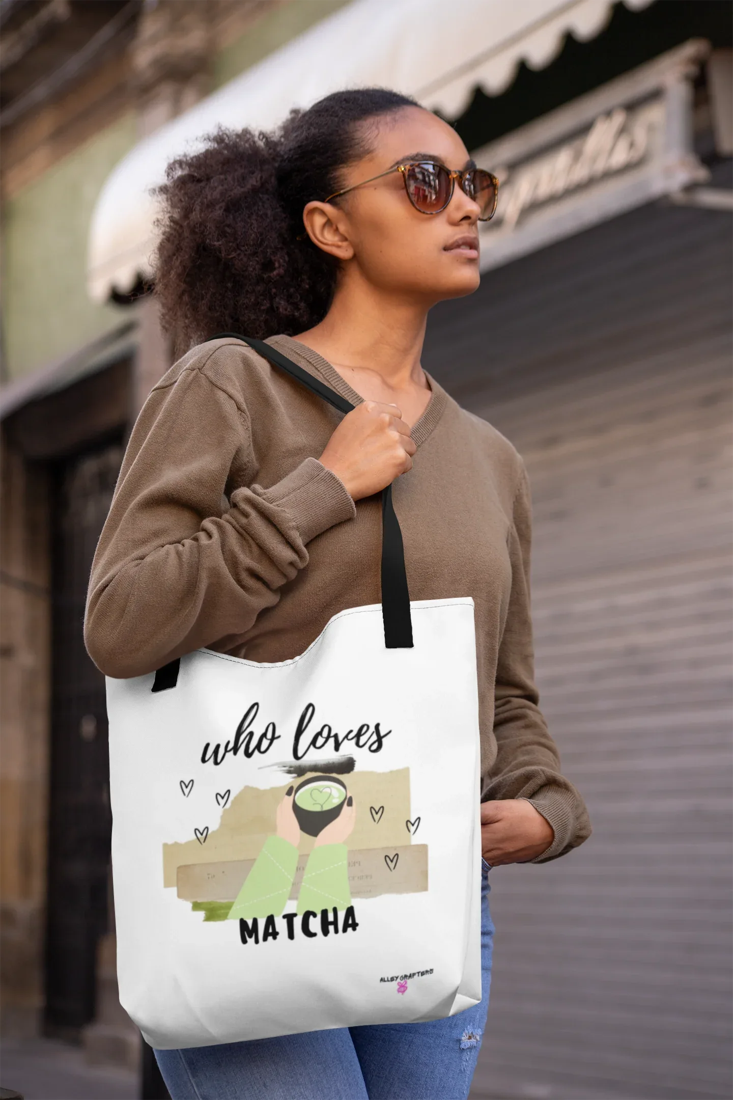 White tote bag on model, with “who loves MATCHA” print and small heart icons.