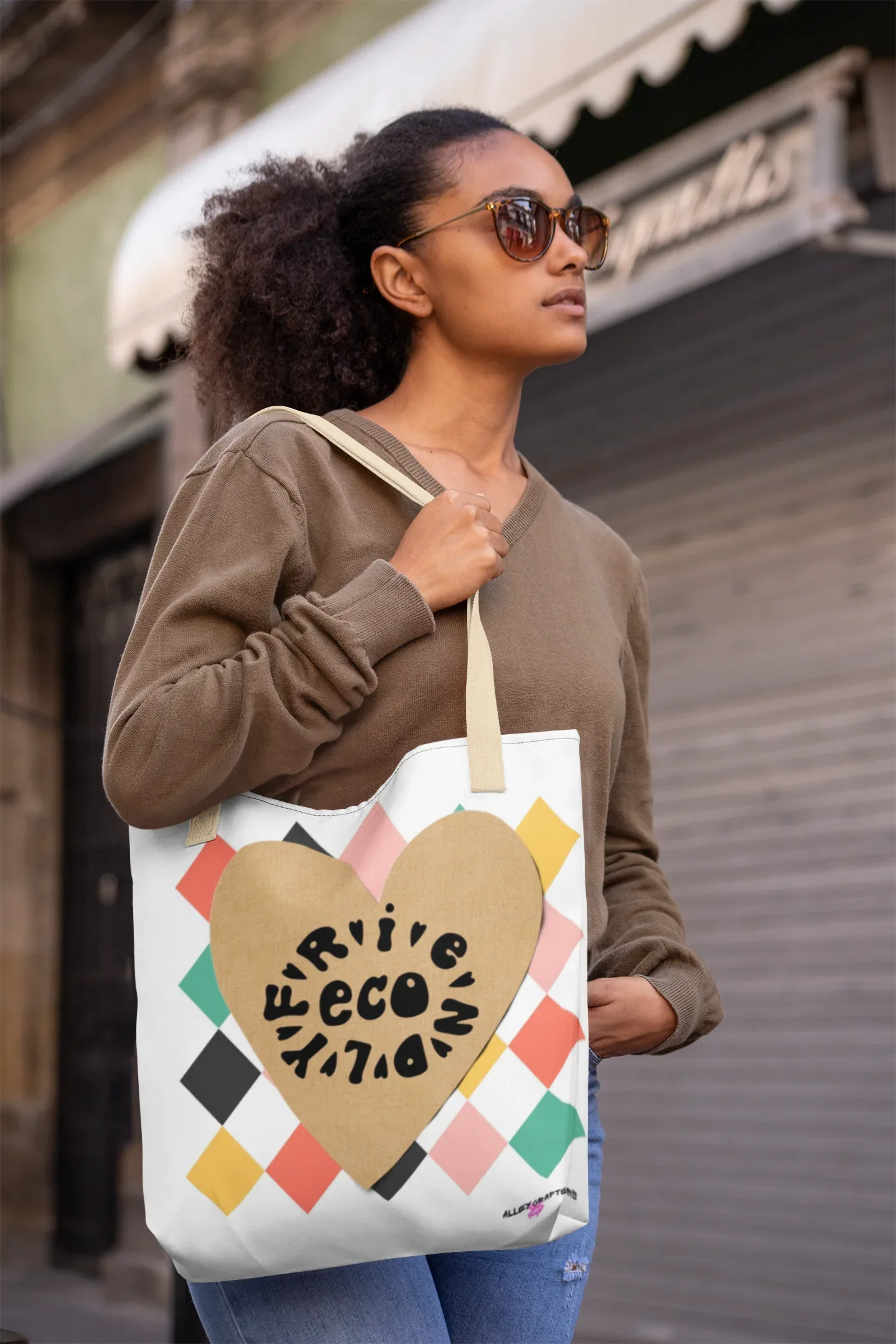 White canvas tote bag with heart logo and multicolor diamond pattern, long handles