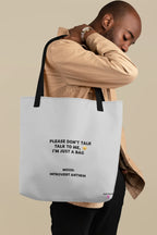 White tote bag with black handles and front slogan print