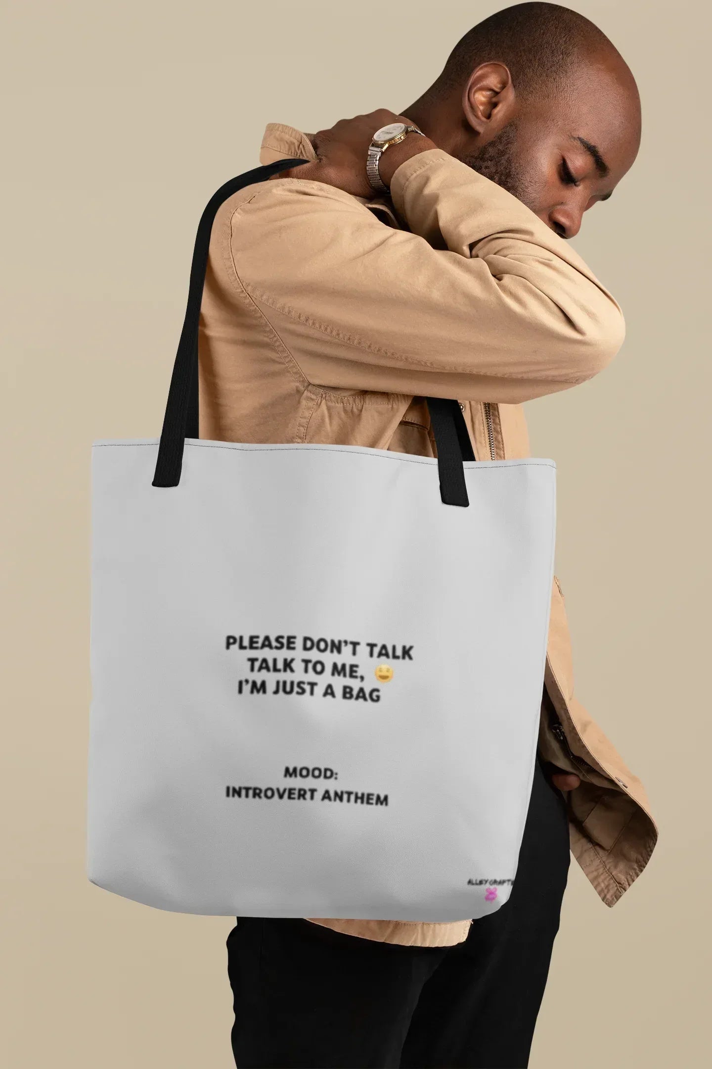 White tote bag with black handles and front slogan print