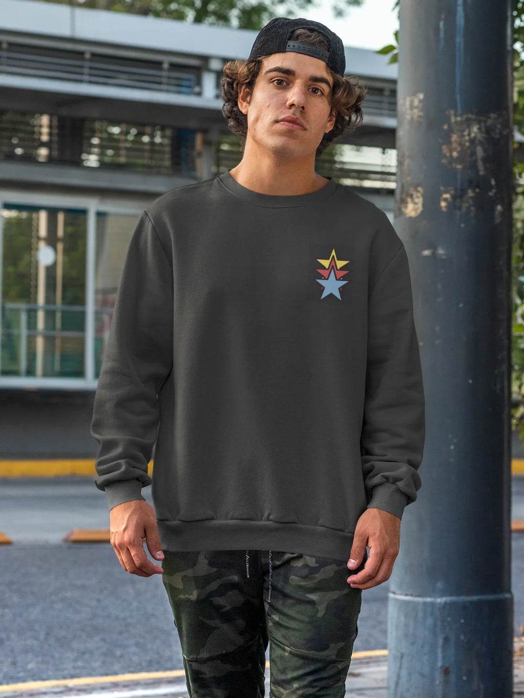 Unisex black crewneck sweatshirt with colorful star embroidery