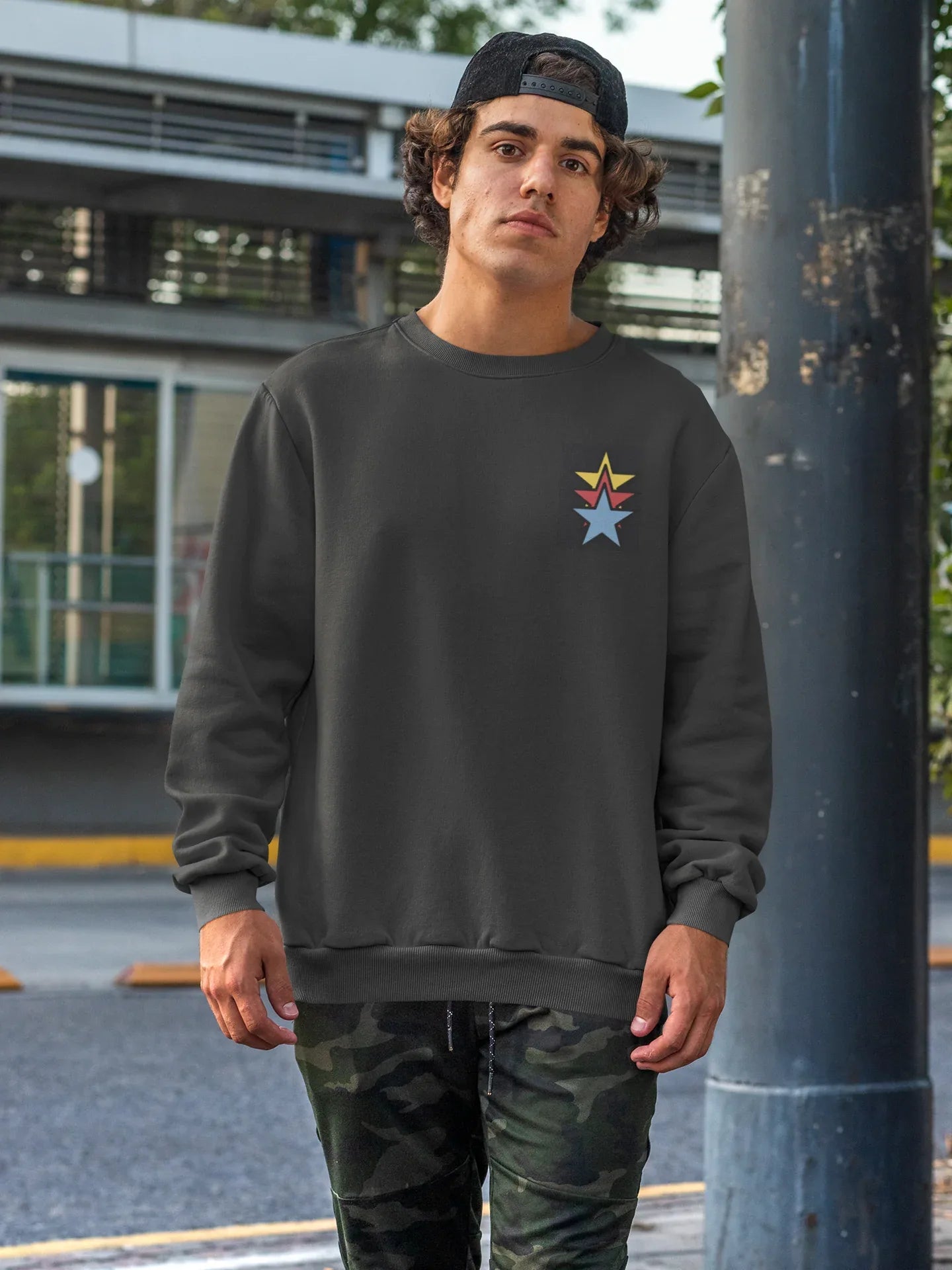 Unisex black crewneck sweatshirt with colorful star embroidery