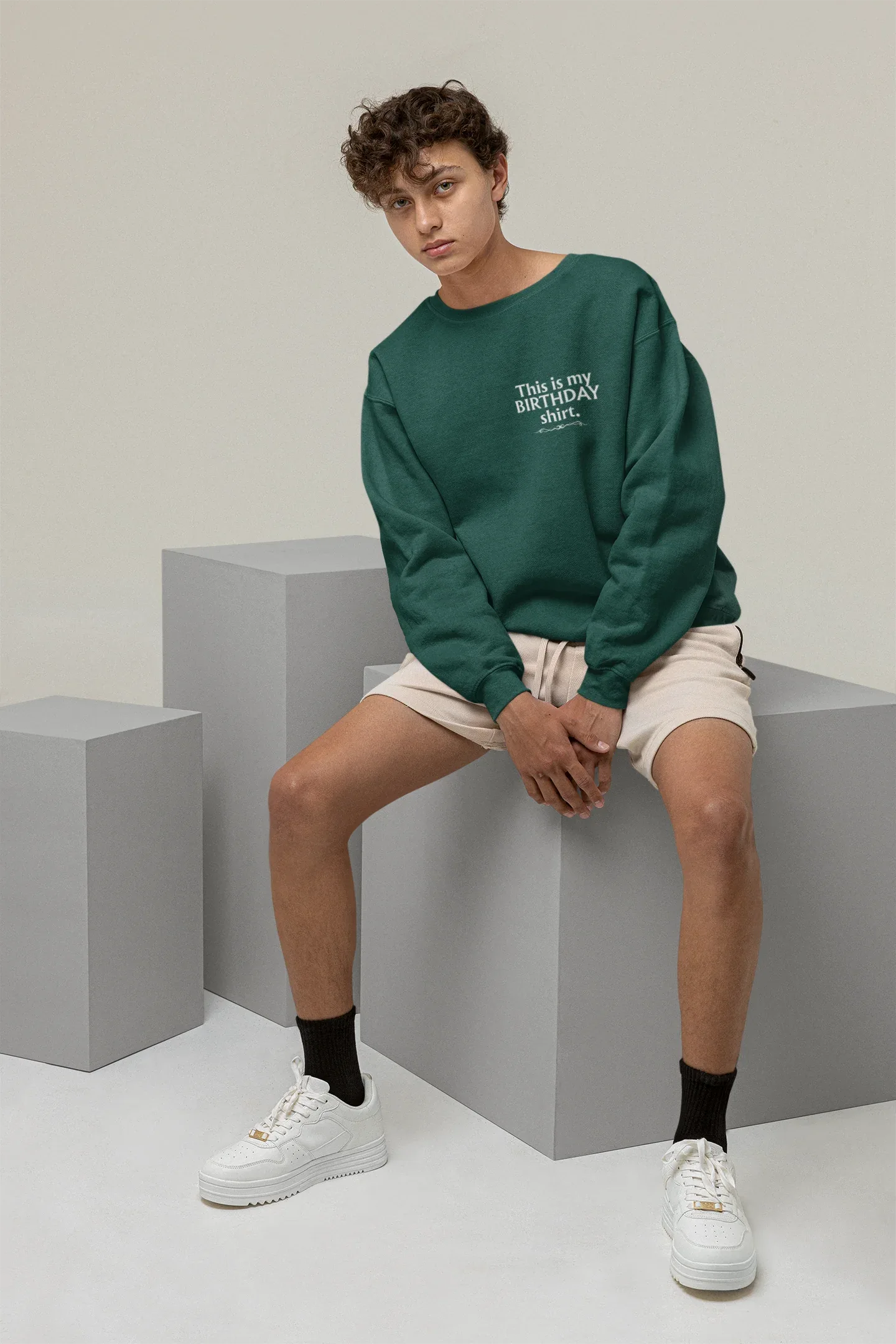 Teal crewneck birthday sweatshirt with small front text graphic
