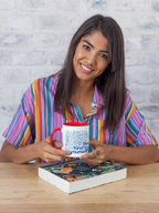 Coffee mug with blue pattern, red rim, Be Kind to yourself text on wooden table