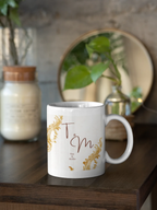 White wedding mug with gold filigree frame and dark red 'T & M' names