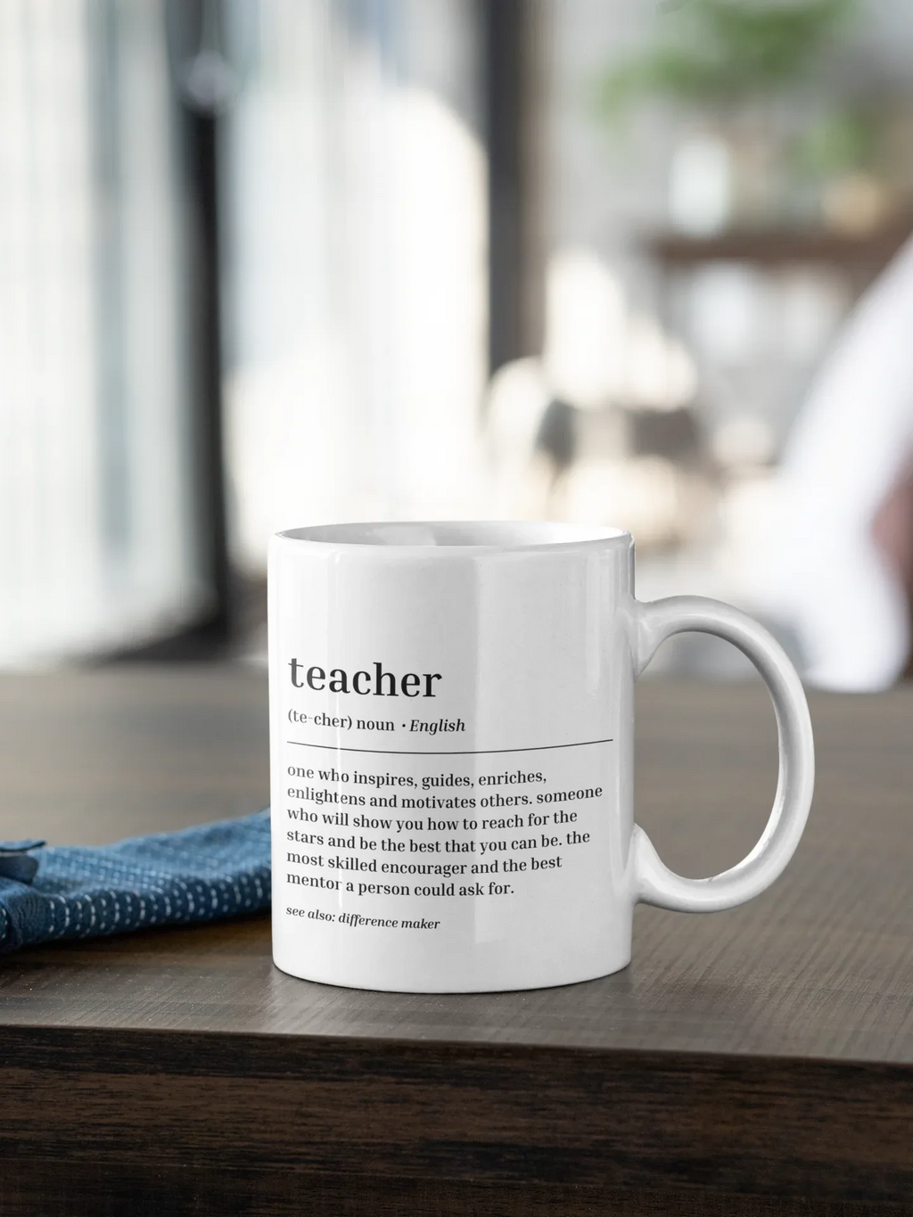 White ceramic teacher mug with 'teacher' text and quote, side view and handle