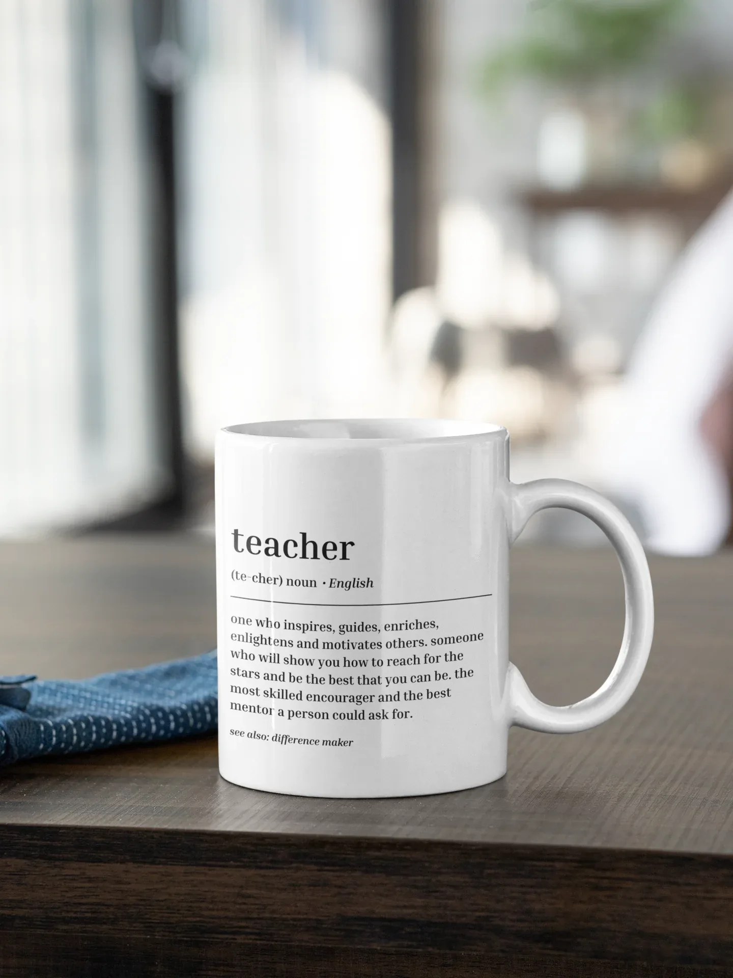 White ceramic teacher mug with 'teacher' text and quote, side view and handle