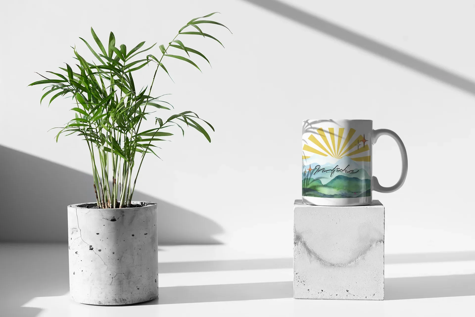 White coffee mug with sunrise rays and mountain landscape print on front