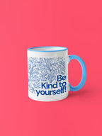 Light blue accent coffee mug with blue floral line art and 'Be Kind to yourself!' message