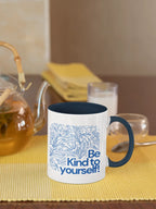 Navy accent coffee mug with blue floral line art and 'Be Kind to yourself!' wording