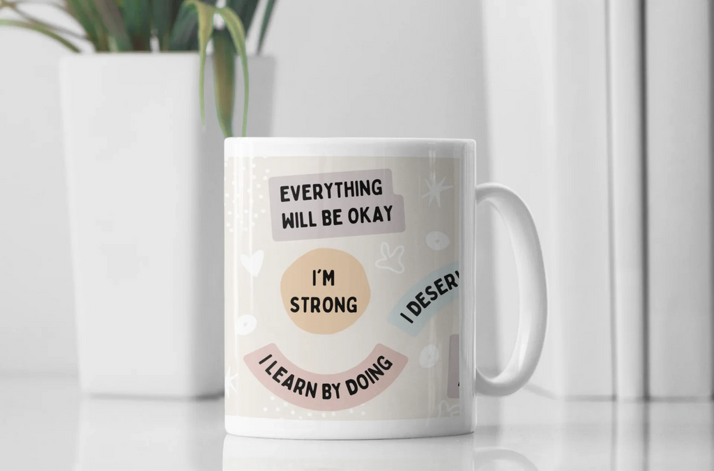 White ceramic positivity mug with text 'Everything will be okay', 'I'm strong', 'Learn by doing'