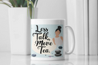 White tea mug with handle and 'Less Talk, More Tea' design with stones