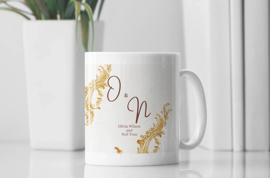 White mug with gold filigree corners and initials O & N, plus Olivia Wilson and Neil Tran