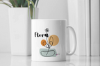 White ceramic mug with Flora name and floral pot graphic on the front