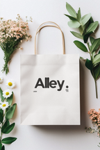 White paper gift bag with “Alley” logo and black icon print
