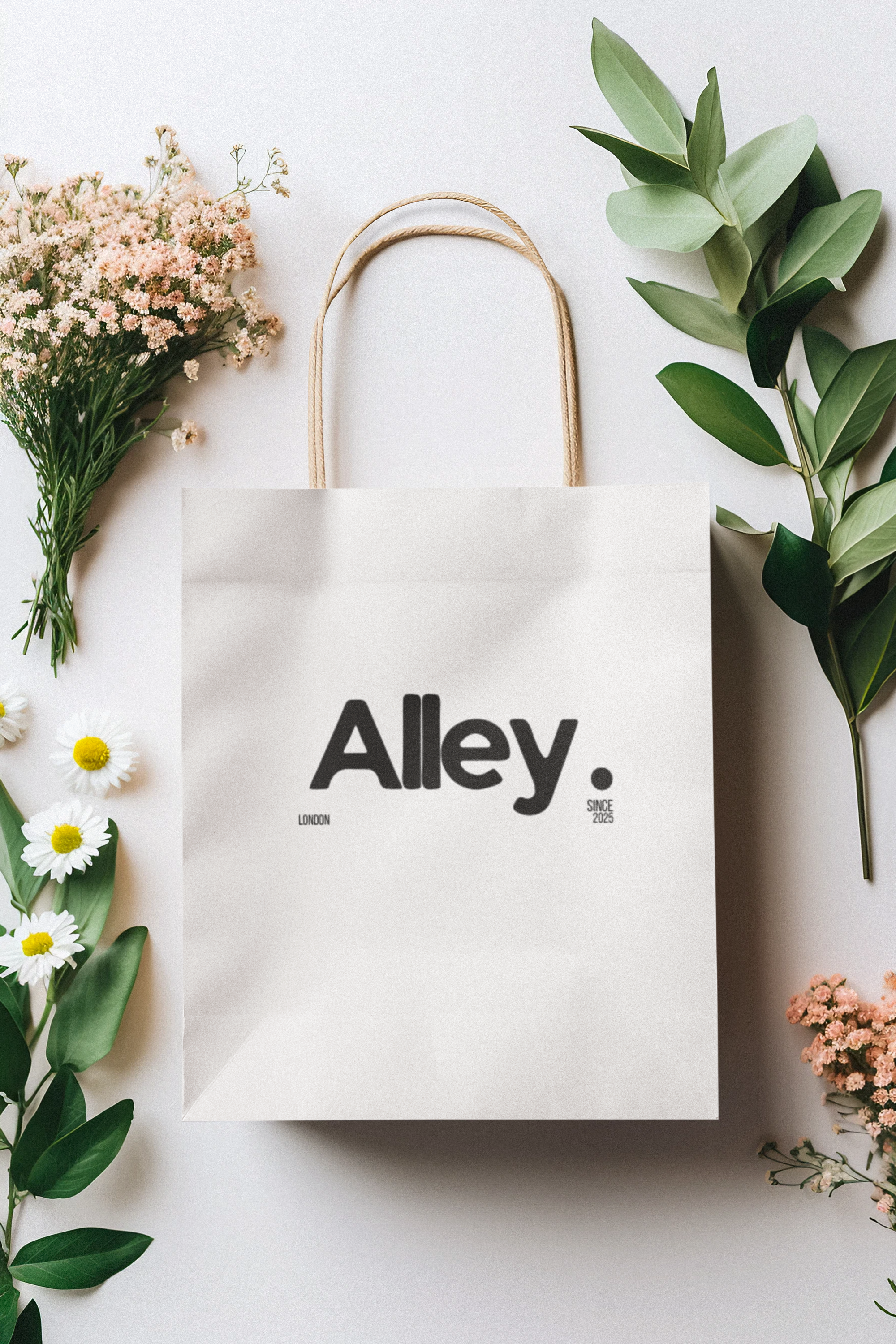 White paper gift bag with “Alley” logo and black icon print