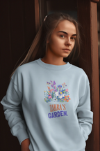 Light blue crewneck sweatshirt with 'Zahra's Garden' floral crest print.