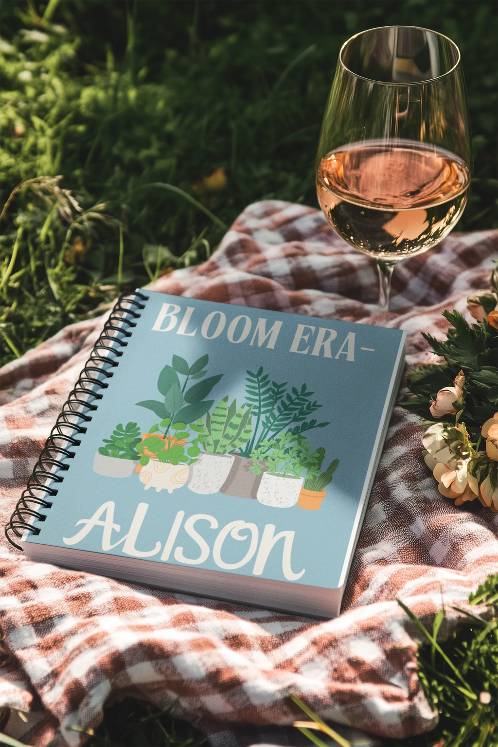 Personalised A5 lined notebook with light blue cover, floral pots illustration and name ALISON.