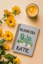 Personalised A5 lined notebook cover with floral pots and name KATE, gray.