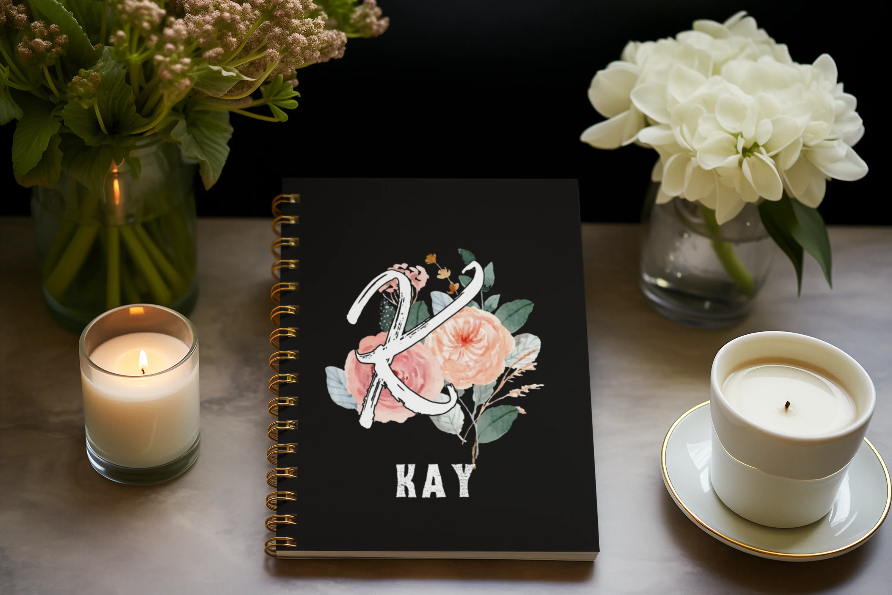 Black wirobound A5 journal with floral initial and name KAY on the cover