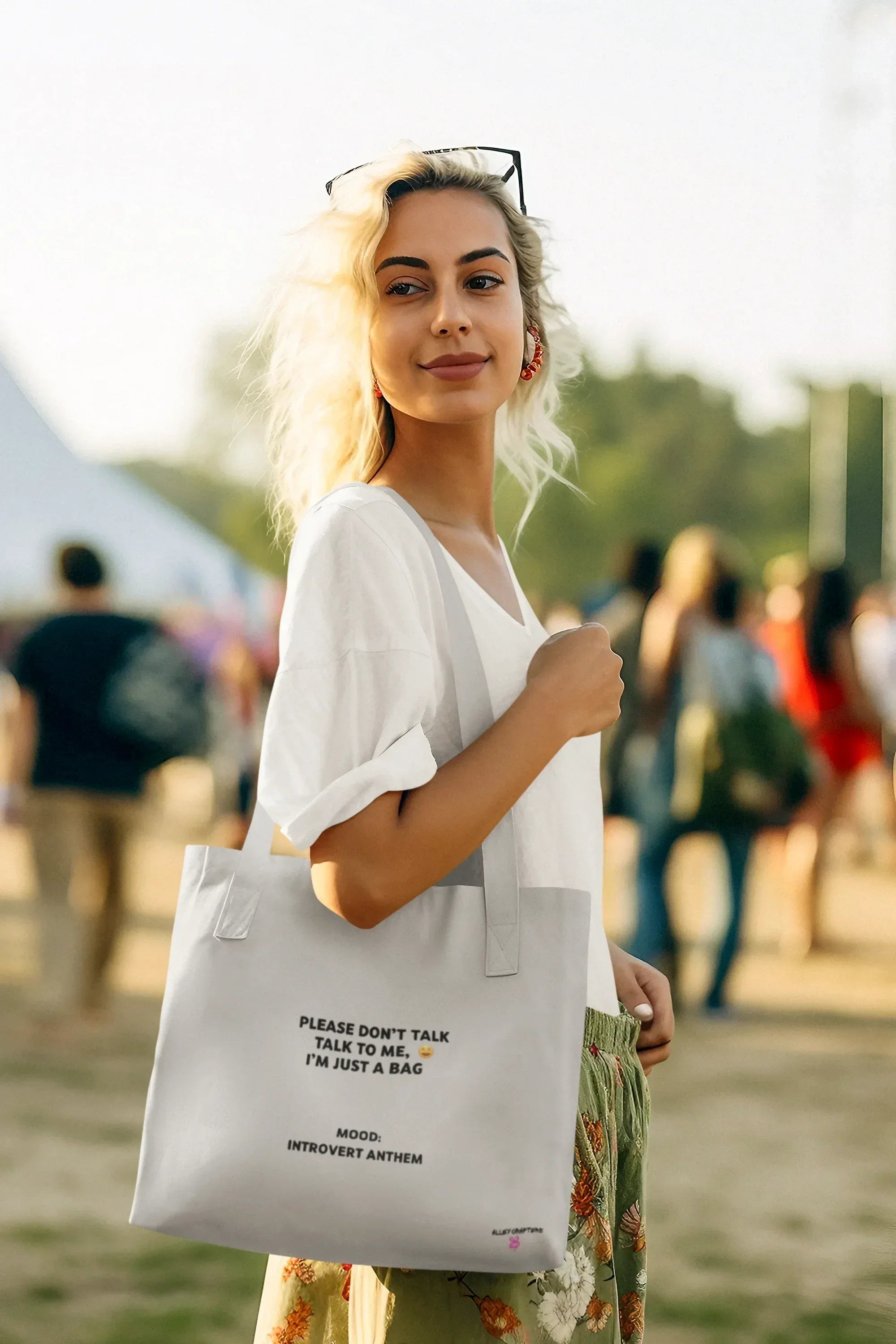 White tote bag with black handles and front slogan print