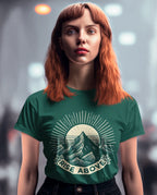 Green short-sleeve T-shirt with mountain sunrise “RISE ABOVE” graphic on model