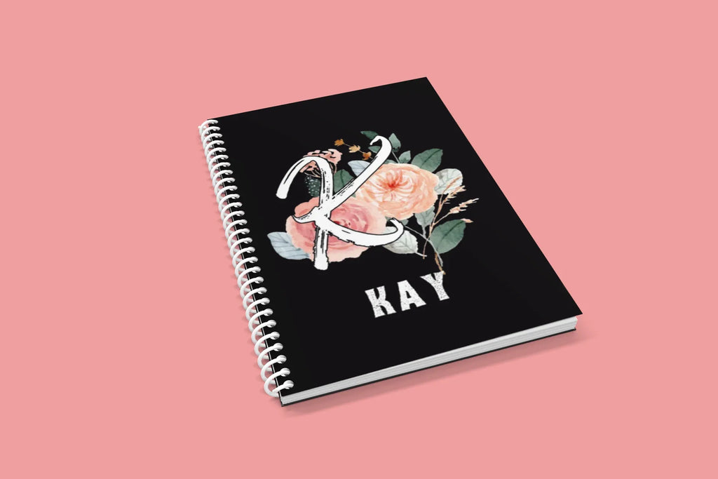 Black wirobound A5 journal with floral initial and name KAY on the cover