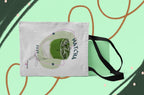 White tote bag with matcha drink graphic, side view, and black shoulder strap