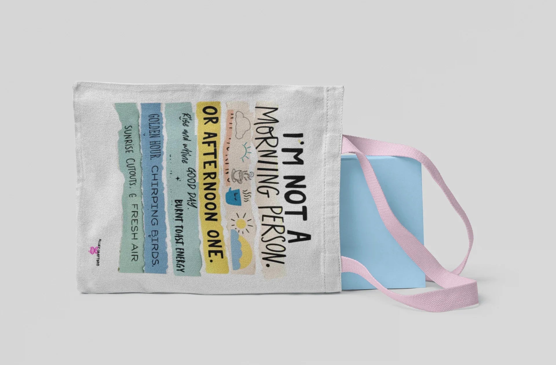 White tote bag with 'I'm not a morning person' and 'or afternoon one' text, side view